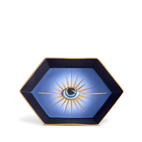 The L’Objet Lito Eye Hexagon Tray is a striking hexagonal porcelain catchall with a gradient blue background, 24-karat gold trim, and a stylized eye surrounded by gold rays.