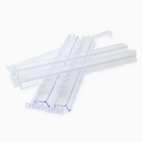 The Oh My Mahjong Mahjong Rack & Pusher Set - Clear features four transparent, rectangular pushers with angled ends, arranged in an overlapping design on a white background—perfect accessories for American Mahjong racks.