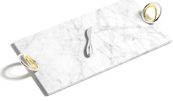 The Anna New York Ring Cheeseboard & Knife Set is a rectangular marble board featuring a stainless steel knife at the center and two metallic rings with yellow accents on opposite corners.