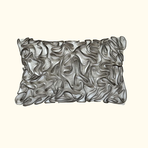 The Threads Soft Goods Zipper Pillow Natural 13 x 20 features sheer, mesh-like fabric and wavy black-edged ruffles for a textured look that stands out beautifully against a light beige background.