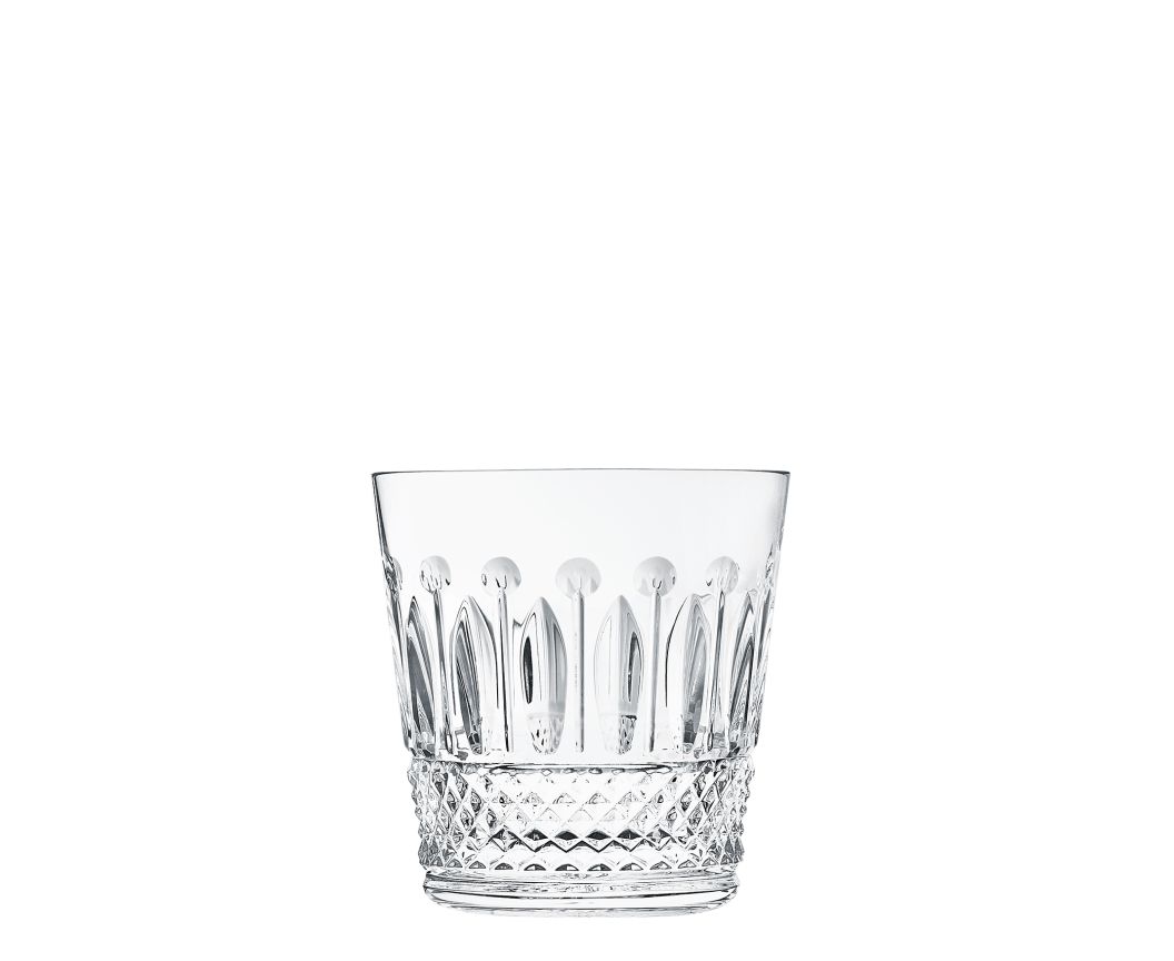The Saint-Louis Tommy Barware tumbler features diamond-cut facets at the base and elongated oval patterns near the top, highlighting fine glasscraft artistry against a plain white background.