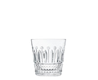 The Saint-Louis Tommy Barware tumbler features diamond-cut facets at the base and elongated oval patterns near the top, highlighting fine glasscraft artistry against a plain white background.