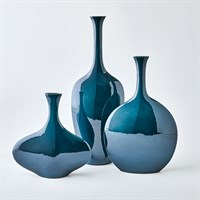 Three Silhouette Reactive Vases in glossy blue by Global Views/Surya are displayed together, featuring varied heights and shapes, reflective surfaces, and elegant elongated necks on a plain white background.