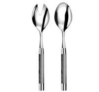 The Capdeco1 Conty Salad Serving Set Grey includes two French-made 18/10 stainless steel salad servers with shiny finishes and gray handles: one slotted spoon and one regular spoon.