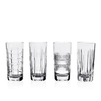The Skye Drinkware Set of 4 by William Yeoward features clear glass tumblers, each with a unique etched design—horizontal lines, vertical cuts, or crosshatch patterns—displayed in a row against a white background.