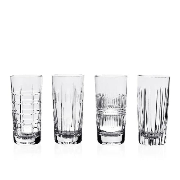 The Skye Drinkware Set of 4 by William Yeoward features clear glass tumblers, each with a unique etched design—horizontal lines, vertical cuts, or crosshatch patterns—displayed in a row against a white background.