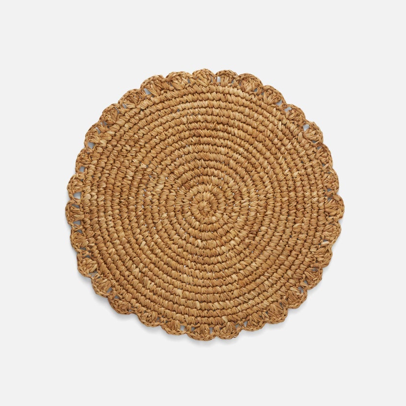 The Amelia Natural Round Placemat Set of 4 by Blue Pheasant features round, woven sisal placemats with frilled edges, crafted from natural straw and shown against a plain white background.