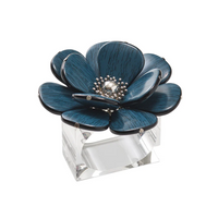 Add a touch of artistry to your décor with this decorative blue flower sculpture featuring a silver center, crafted from metal and set on a clear rectangular acrylic base—reminiscent of the elegant Begonia Napkin Rings Set of 4 in Teal by Kim Seybert.