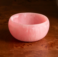A Resin Sorbet Mini Bowl in Raspberry by Beatriz Ball sits on a polished wooden surface—an elegant gift for hostess occasions.