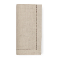 A set of four beige Festival Napkins by Sferra, crafted from fine European linen with a decorative hemstitch border, neatly folded and shown against a white background.