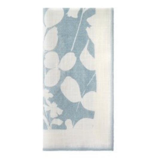 The Bodrum Fleur de Lin Napkin Set of 4 - Blue features folded cotton napkins with a blue and white leaf and flower silhouette pattern, rectangular shape, and white border—ideal for pairing with floral linens or a matching runner.