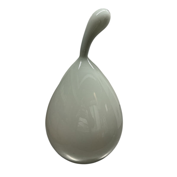 The Volume Vessel Dove Grey by Tyler Barry Design is a smooth, glossy, teardrop-shaped handblown glass piece with an elongated curved tip—ideal as a sculptural accent for artisan home decor.