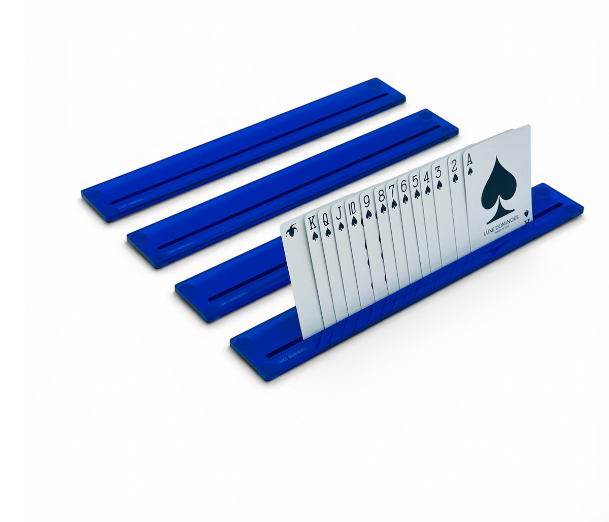 Four vibrant blue plastic card racks from the Luxe Canasta & More Card Racks Set by Luxe Dominoes serve as practical and stylish holders, neatly displaying a full suit of spade playing cards—arranged in order from ace to king—with each card standing upright and clearly visible.