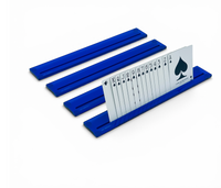 Four vibrant blue plastic card racks from the Luxe Canasta & More Card Racks Set by Luxe Dominoes serve as practical and stylish holders, neatly displaying a full suit of spade playing cards—arranged in order from ace to king—with each card standing upright and clearly visible.