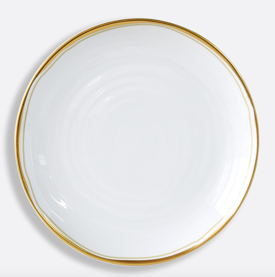 The Albatre Dinnerware - Gold by Bernardaud is a minimalist white ceramic plate with a thin gold rim, viewed from above on a light background—effortlessly capturing refined wabi-sabi elegance.