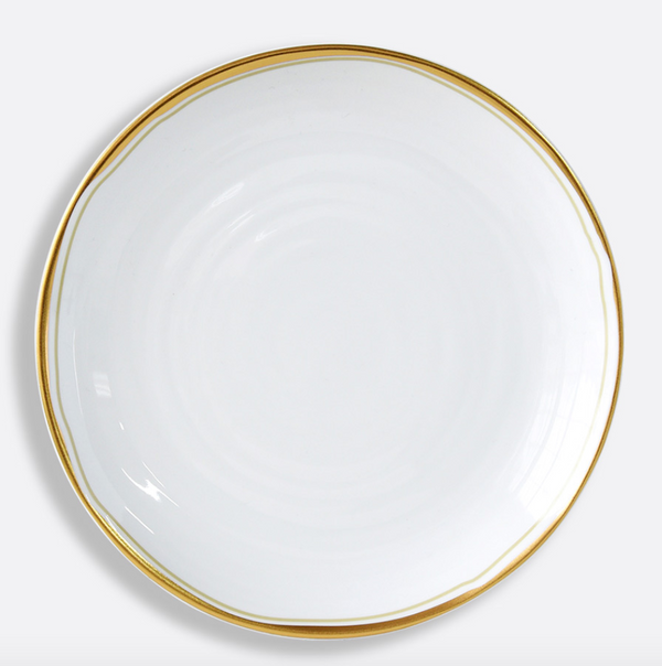 The Albatre Dinnerware - Gold by Bernardaud is a minimalist white ceramic plate with a thin gold rim, viewed from above on a light background—effortlessly capturing refined wabi-sabi elegance.