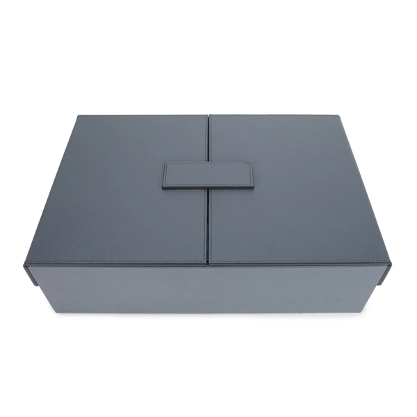 A closed, rectangular Excelsior Steel Grey Rumi Set by Brouk & Co with a central flap and minimalist design rests on a white background—an elegant storage case for your board game set.