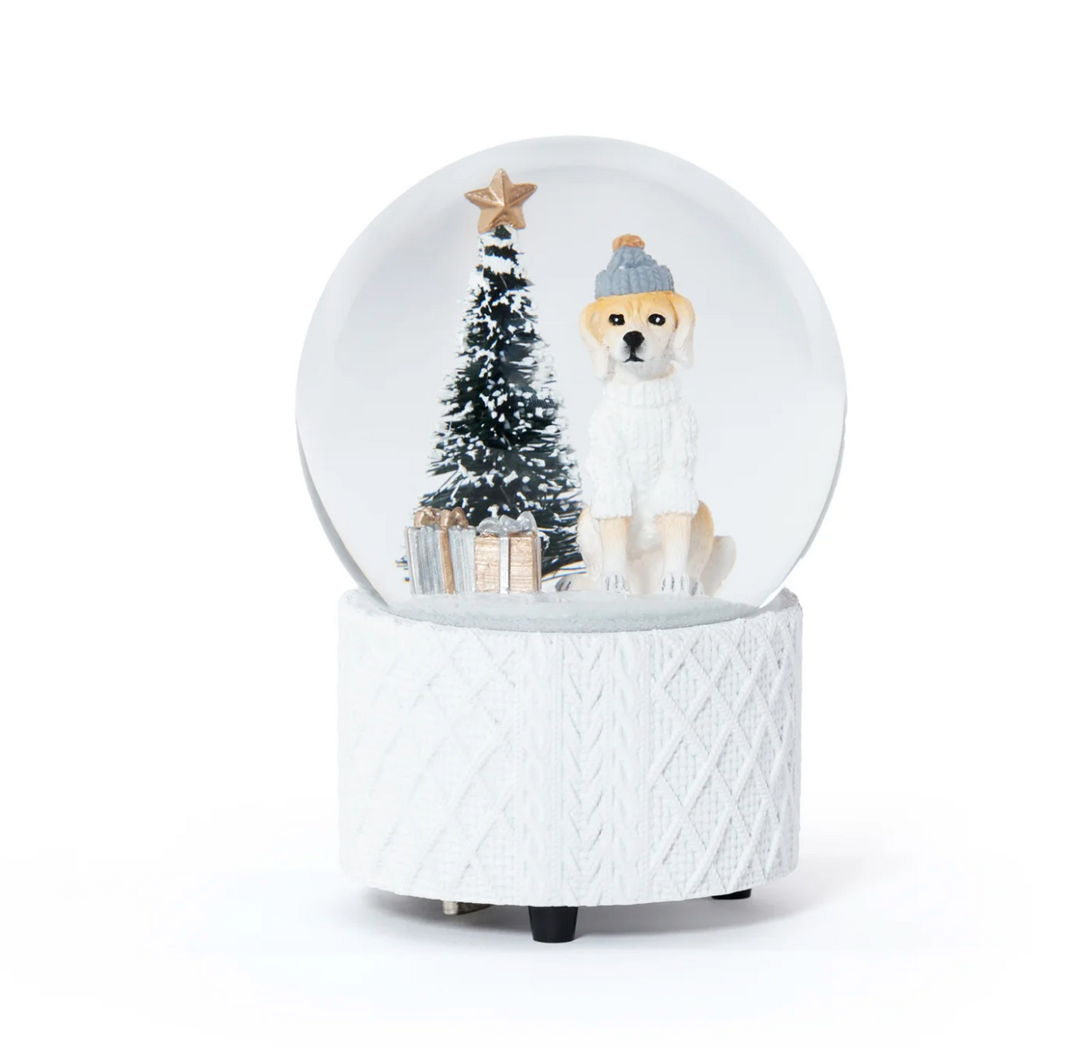 A Zodax Dog w/ Sweater Snow Globe featuring a dog in a beanie, a Christmas tree, and wrapped gifts, sitting on a textured white base.