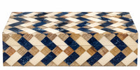 Introducing the Brett Bone Box by A Sanoma Inc — a rectangular box featuring a captivating geometric pattern of blue, beige, and white diamonds on both the lid and sides. This visually striking tiled design brings modern flair to any setting. Perfect as an accent piece, the Brett Bone Box effortlessly elevates your space with its bold, contemporary aesthetic.