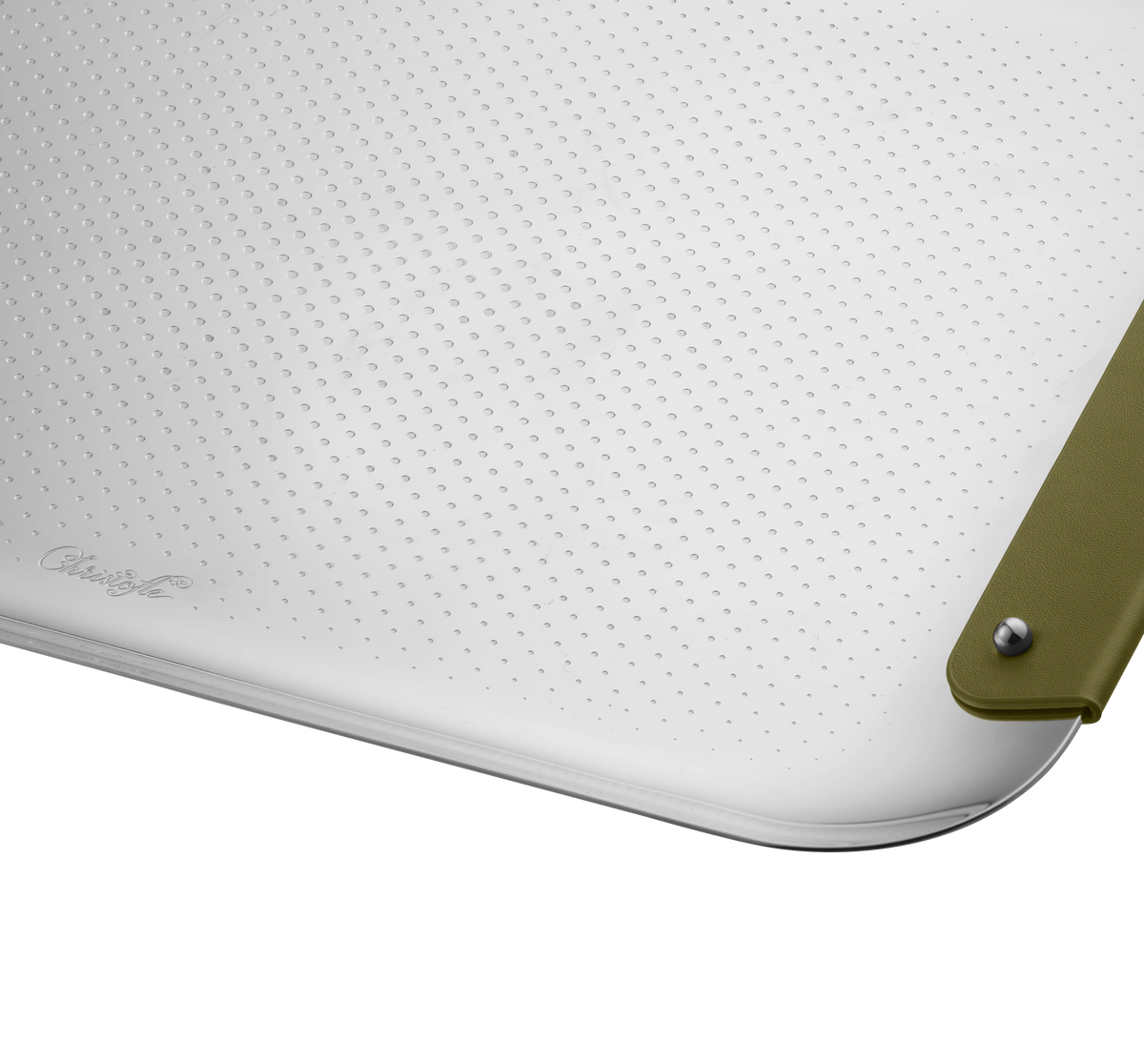 Close-up of Christofle’s Club Rectangle Tray - Stainless Steel Imperial (13" x 9"): white textured surface with small uniform dots, rounded corner, imperial green leather strap with metal rivet, and a subtle embossed logo on the lower left.