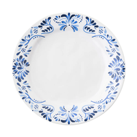 The Juliska Iberian Dinnerware features a round white ceramic dinner plate adorned with a blue floral and leaf pattern inspired by cobalt blue Iberian Journey tiles on a plain white background.