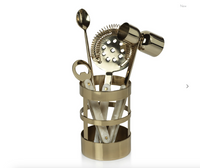 The Zodax Armor Gold 5 Piece Bar Set includes a spoon, strainer, jigger, bottle opener, and holder—all with ivory handles and a gold finish—making it an elegant addition to any home bar.