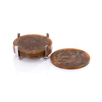 The Spector Round Coaster Set by Zodax features four amber marbled coasters stacked in a polished nickel holder, with one coaster displayed beside it—ideal for the modern host.