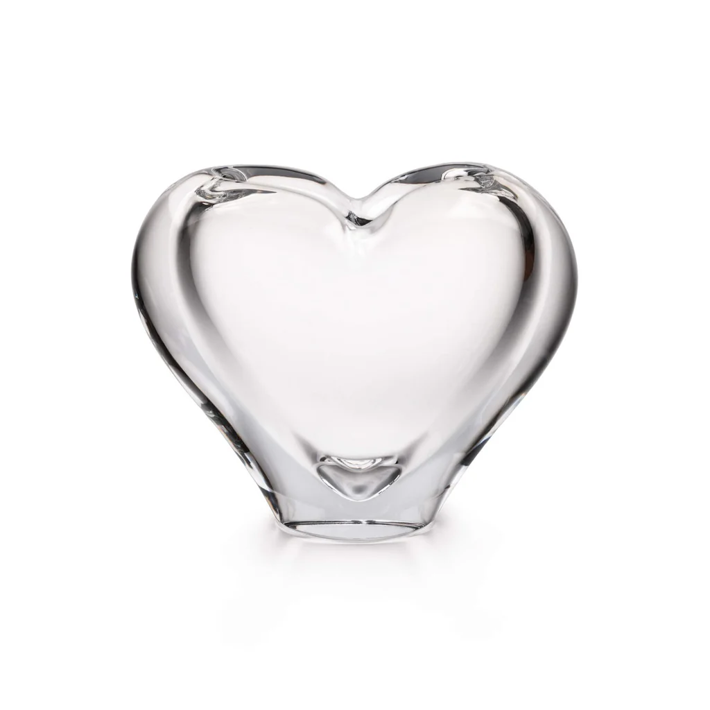 The Simon Pearce Romance Vase - Large is a clear, smooth glass sculpture shaped like a heart, displayed against a plain white background.
