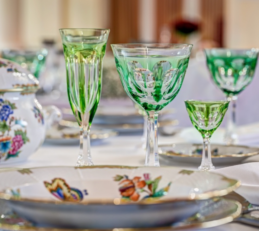 An elegant table set with Moser Lady Hamilton Champagne Glasses (140ml) and floral-patterned porcelain dishes atop a white tablecloth creates a refined, festive dining atmosphere.