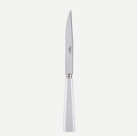 The Sabre Icone 5pps serrated butter knife features a white handle, stainless steel blade with SABRE PARIS engraving, and is dishwasher safe.