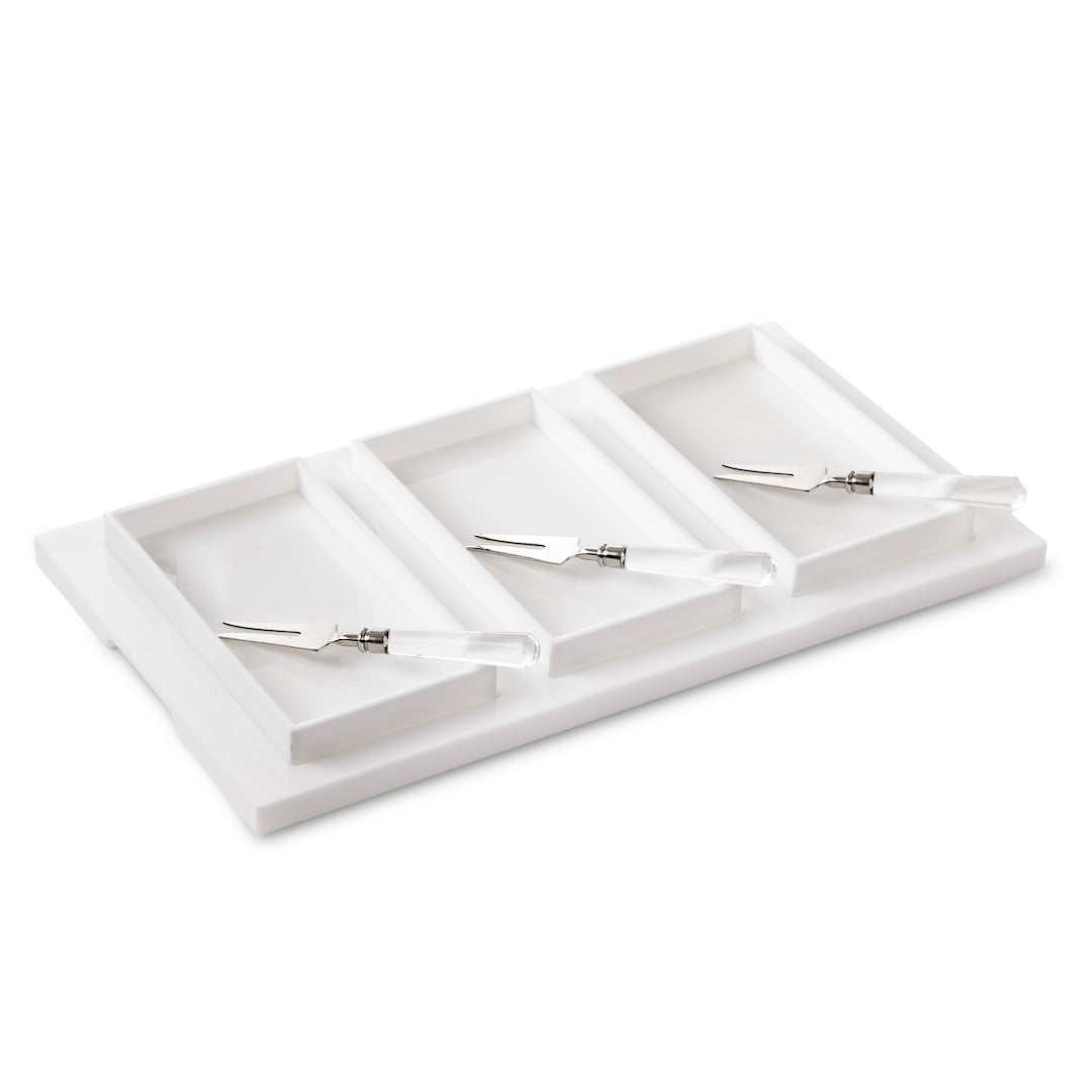 The Inspired Generations Bright White Brunch Board is a rectangular white tray featuring four compartments, each with a small metal knife or spatula sporting a clear handle—an ideal choice for organizing brunch essentials or serving in style at your next gathering.