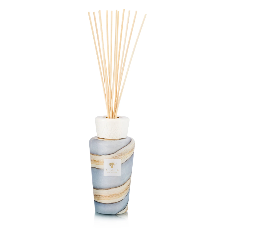 The Baobab Sand Sonora Diffuser features a marbled gray and beige ceramic bottle, designed to elevate your interior decor. Slim wooden reeds extend gracefully from the top of this refillable diffuser, filling your space with enduring fragrance.