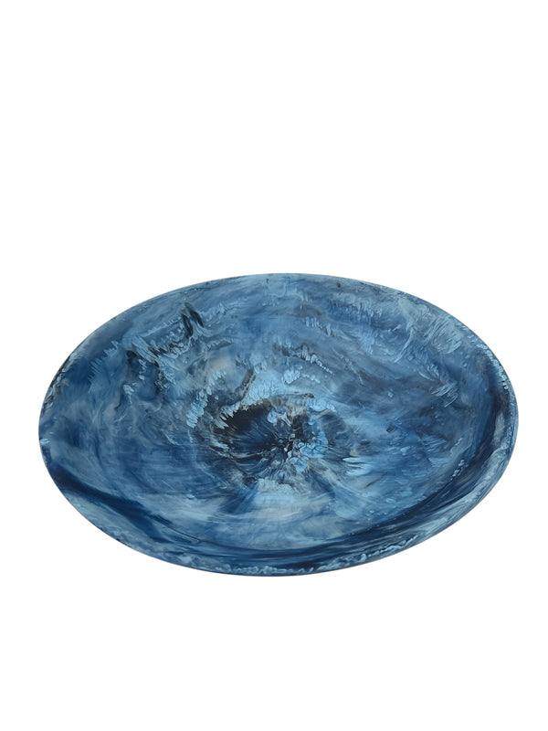 The Swirl Colored Resin Everyday Bowl by Nashi Home features a round, shallow design with blue and white marbled swirls, creating a striking handcrafted decor accent against any plain background.