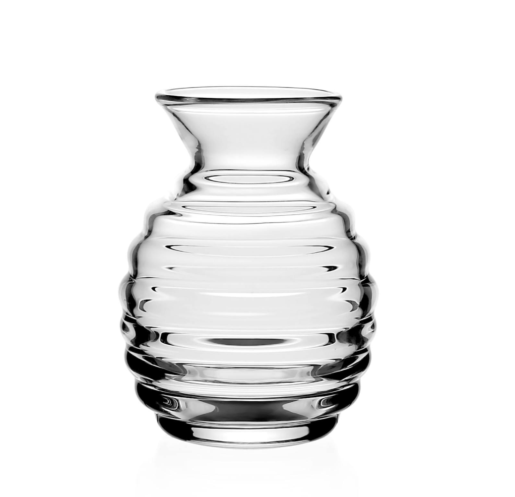 The William Yeoward Ripples Posy Vase 4.75" features a clear glass body with a flared rim and horizontal ridges, offering a modern, minimalist look. Shown here on a white background, its rounded ribbed design adds elegant style.