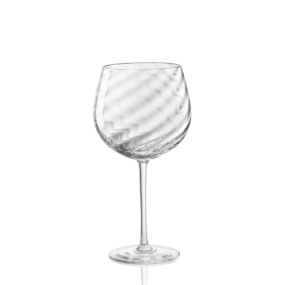 The Tolomeo Red Wine Glass by Nason Moretti features a long stem, gently curved bowl, and subtle swirling blown glass pattern. Shown empty against a white background. Hand wash recommended.