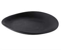 The Simon Pearce Barre Dinnerware Slate is a black, round, slightly irregular stoneware plate with a matte finish—perfect for modern dinnerware sets.