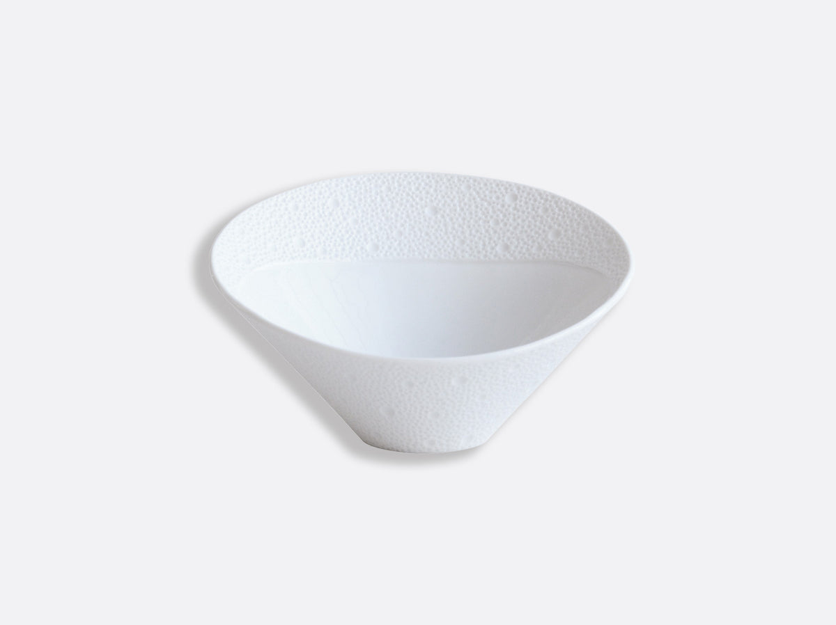 The Ecume White Dinnerware by Bernardaud features a white, cone-shaped bowl with a textured, dimpled rim, crafted from fine Limoges porcelain.
