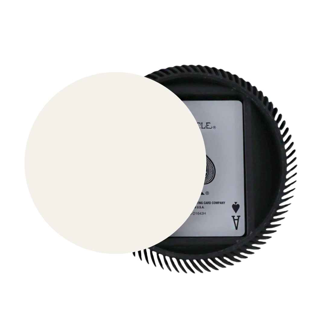 The La Redonda Round 3D Single Card Deck Holder by Luxe Dominoes in black features ridged edges and holds a deck of playing cards, partially covered by a large off-white circle with the ace of spades visible.