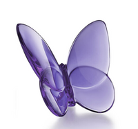 The Baccarat Papilion Lucky Butterfly is a translucent purple crystal figurine with smooth, curved wings and a glossy finish, beautifully displayed against a plain white background.