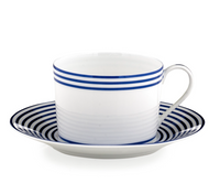 A white Latitudes Dinnerware teacup by Royal Limoges features blue horizontal stripes and sits on a matching saucer, both crafted from fine Limoges porcelain.