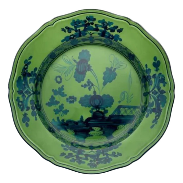 The Oriente Italiano Dinnerware Malachite by Ginori 1735 is a decorative green ceramic plate with scalloped edges, featuring elegant blue floral and botanical patterns for timeless Italian tableware style.