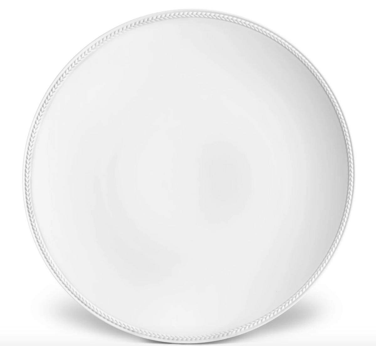 The Soie Tressée White Dinnerware by L'Objet is a round, ceramic dinner plate in white with a subtle braided border, shown from above on a white background.