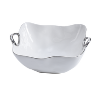 The Handle Bowl Silver Trim by PAMPA BAY is a glossy white ceramic bowl with curved edges and two silver handles, crafted from high-fired porcelain and shown on a plain white background.