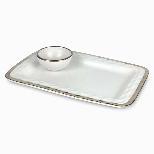 The Michael Wainwright Truro Platinum Edge Chip & Dip is a handmade rectangular white ceramic platter with a raised edge, subtle gray trim, and a matching round bowl in one corner, inspired by elegant design.