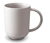 The L'Objet Terra Stone Dinnerware mug features a plain, light gray ceramic design with a large handle, inspired by hand-crafted dinnerware, and is shown against a white background.