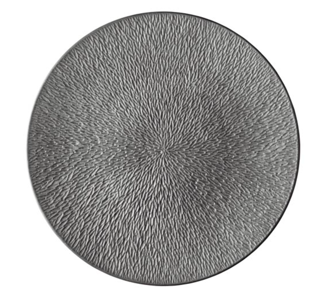 The Raynaud Mineral Irise Dinnerware in Dark Grey features a round, textured design with dense, radiating lines that create a ripple effect—reminiscent of fine Limoges porcelain crafted in France.