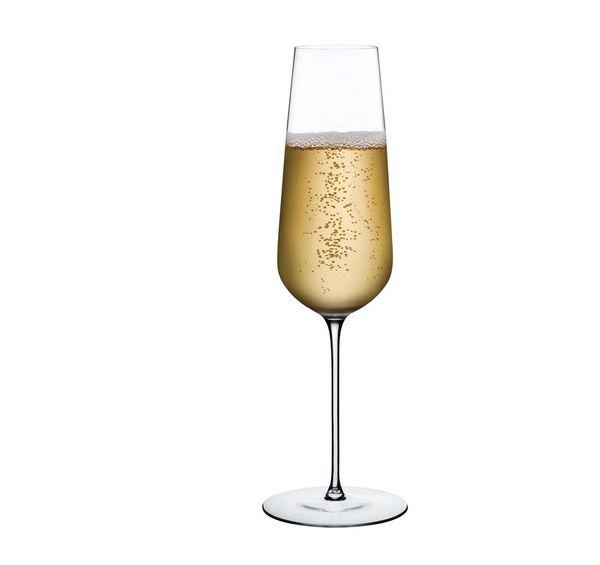 A tall, clear Nude Glassware Stem Zero Flute Champagne Glass holds sparkling wine with tiny bubbles rising, set against a plain white background.