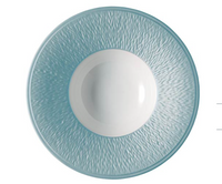 The Raynaud Mineral Irise Dinnerware Sky Blue plate, made in France, features a textured light blue rim and smooth white center. Seen from above on a white background.