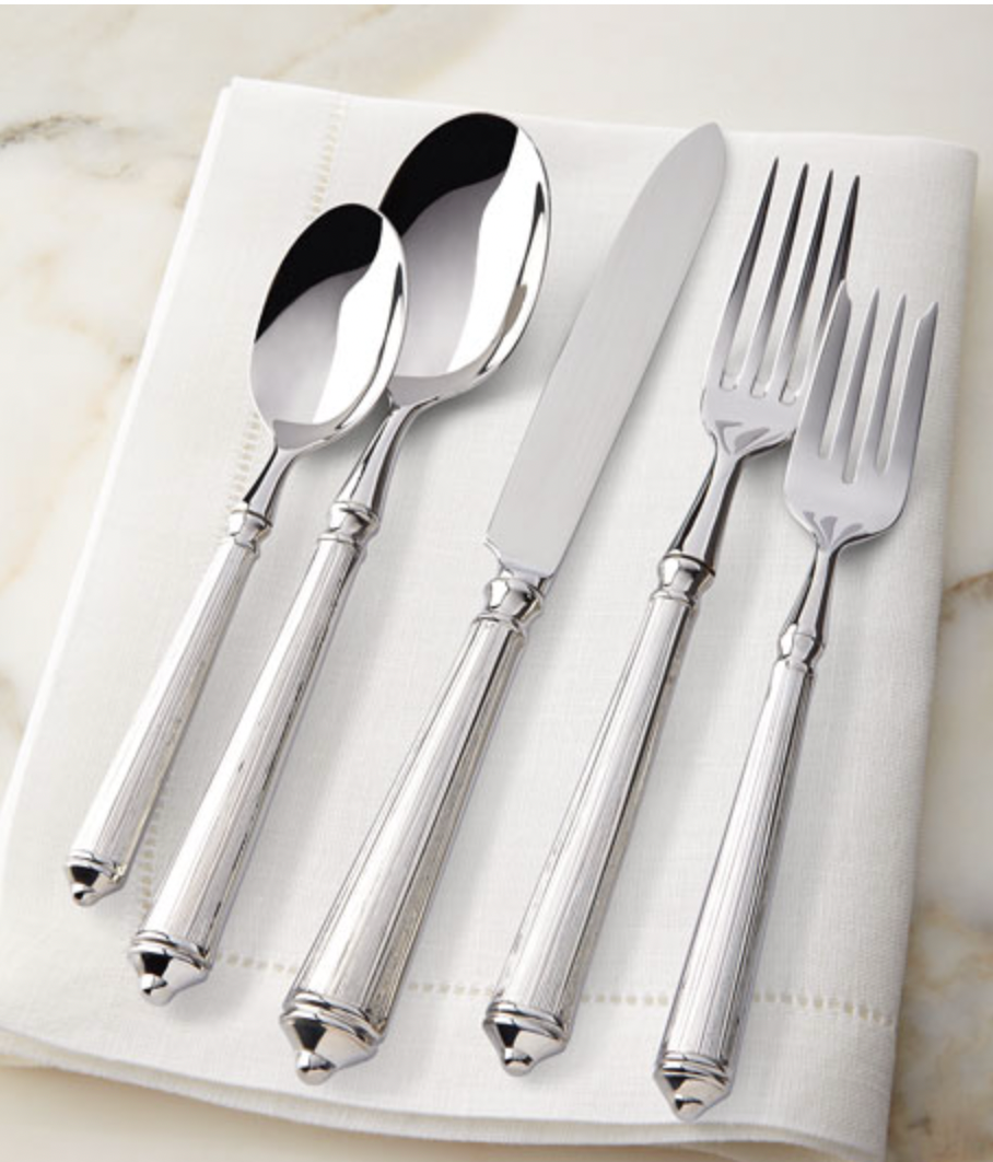 The Ricci Rialto Flatware 5-Piece Setting is displayed on a folded white napkin atop a light marble surface.