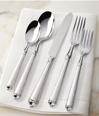 The Ricci Rialto Flatware 5-Piece Setting is displayed on a folded white napkin atop a light marble surface.